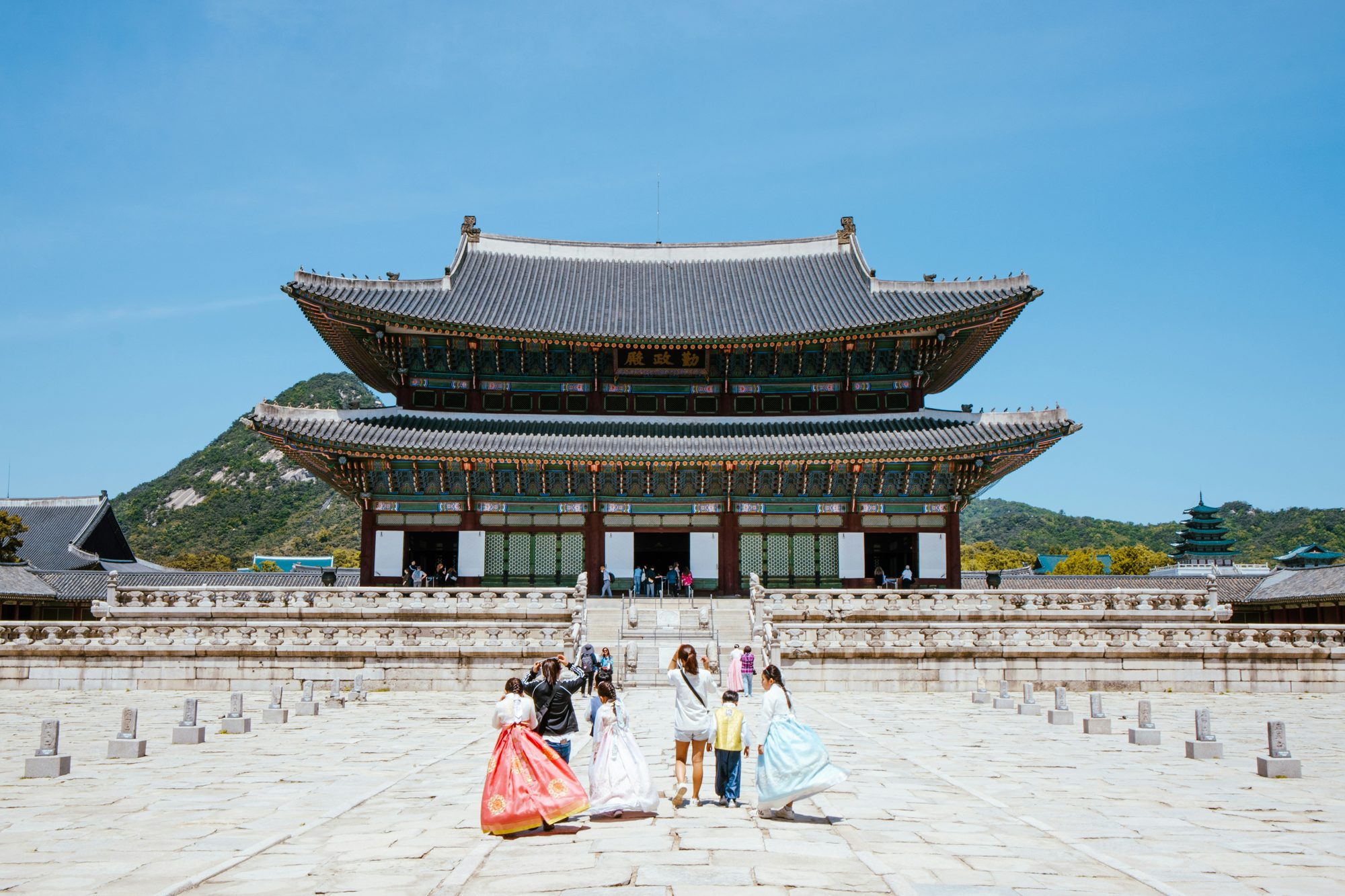 Women in traditional hanbok at a Korean palace on a luxury group trip